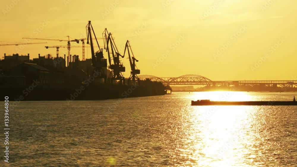 Timelapse with silhouette of tanker on industrial port and sunset background Timelapse with silhouette of tanker on industrial port and sunset background