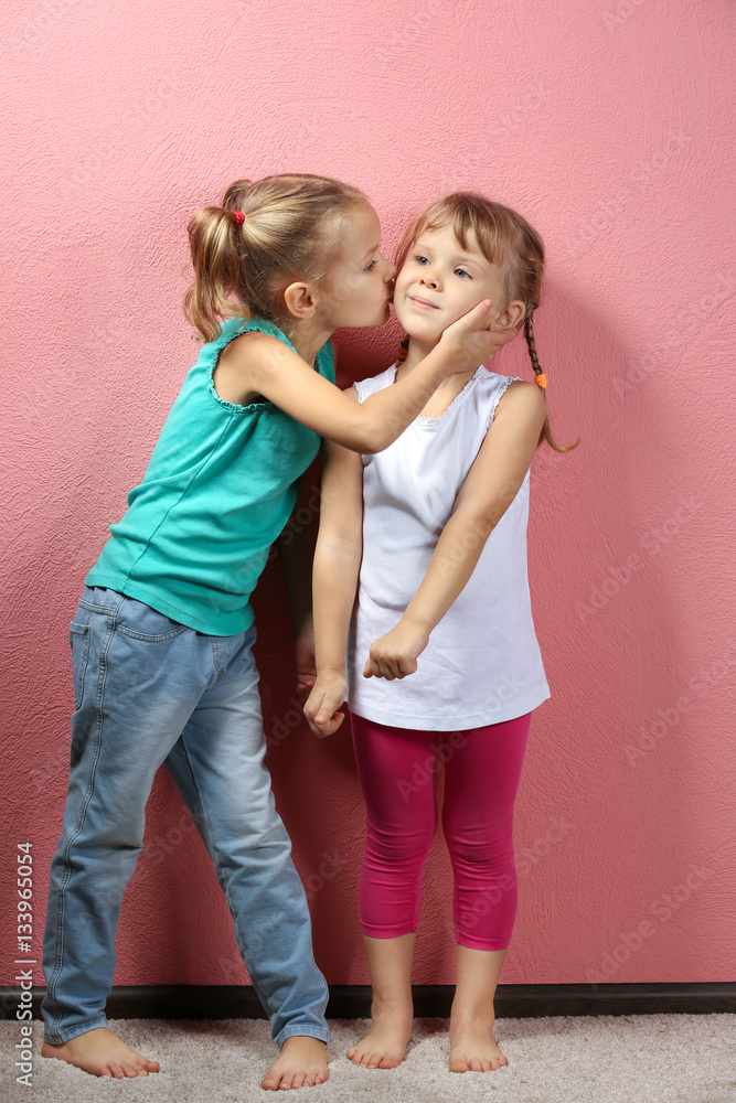 Adorable little girls on pink background Adorable little girls on pink background