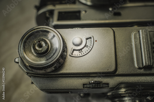 Fotografie Close up view from above of old Russian analog film camera on dirty canvas with vintage look
