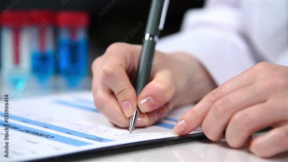 Woman Therapist Filling Medical Form Patient Sitting In Clinic. Close Up Woman Therapist Filling Medical Form Patient Sitting In Clinic. Close Up