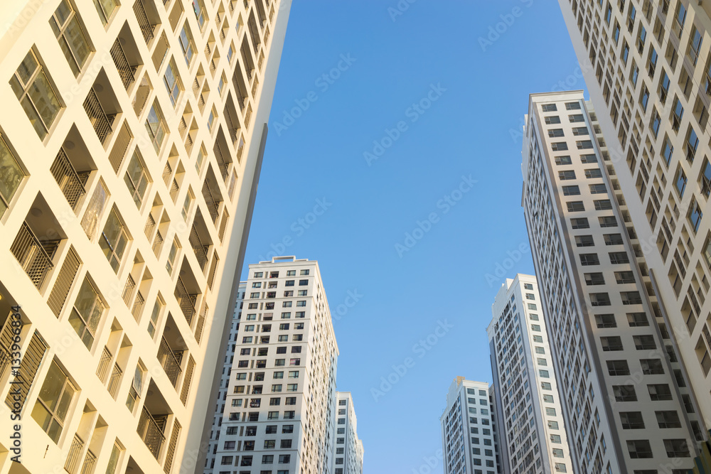 Resident apartment buildings against blue sky. Real estate background