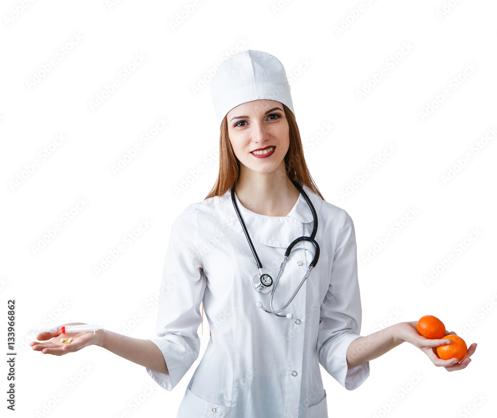 A young attractive woman doctor holding a pills and tangerines, isolated on a white background A young attractive woman doctor holding a pills and tangerines, isolated on a white background