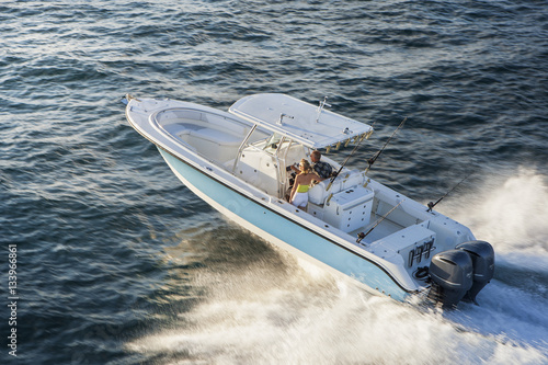 High angle view of couple travelling on speedboat at sea photo