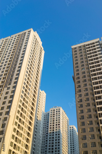 Resident apartment buildings against blue sky. Real estate background