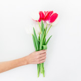 Bouquet with flowers in hands isolated on white background. Flat lay,