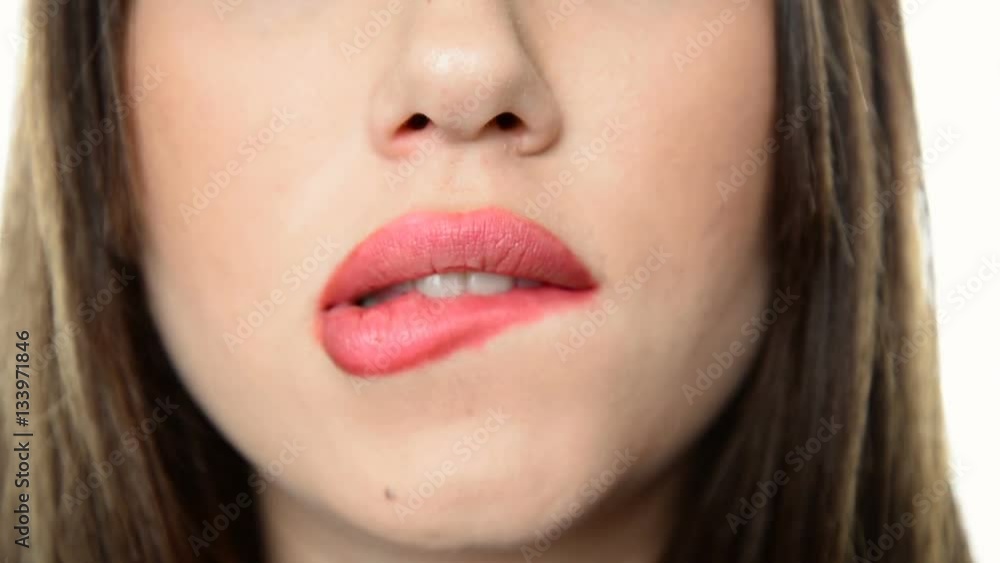 Close-up of sensuous woman mouth bite her fleshy red lips Close-up of sensuous woman mouth bite her fleshy red lips