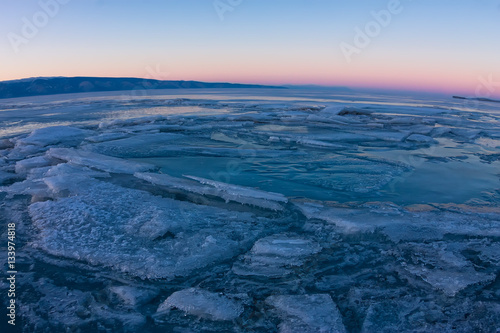 textured tile blue ice hummock of Lake Baikal at sunset. Olkhon