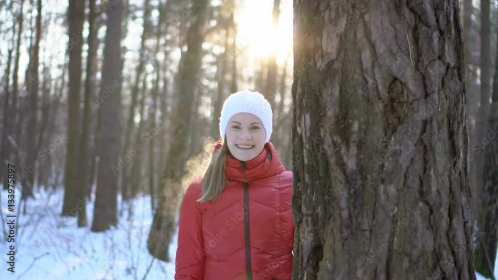 Beautiful young woman in winter park, having fun, smiling. Slow motion video.