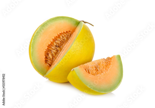 portion cut fresh yellow melon with stem on white background