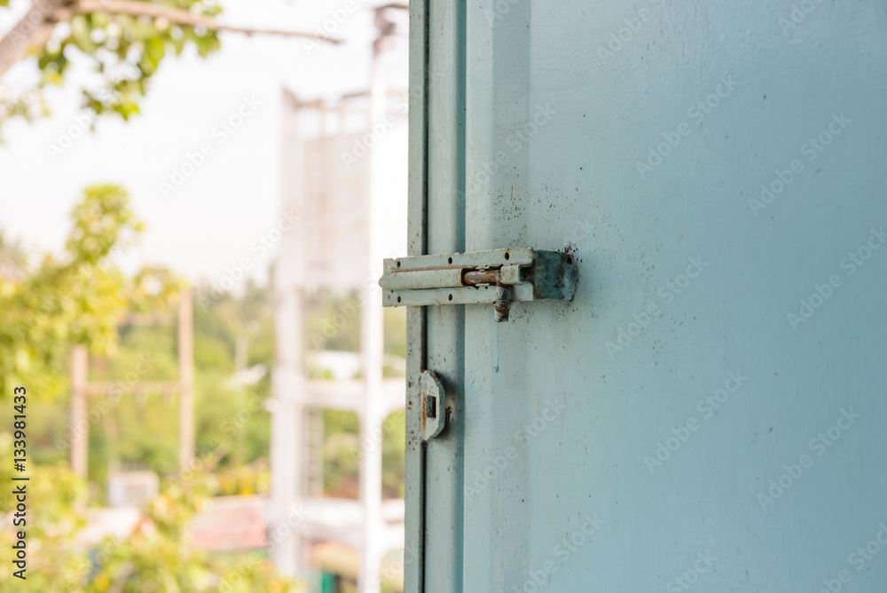 Old lock on the metal window. latch of bar lock at the old windo Old lock on the metal window. latch of bar lock at the old windo