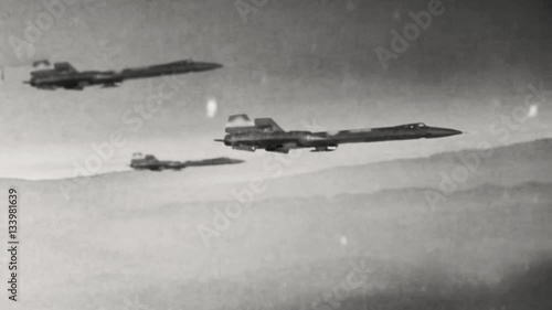 Animation of old style warplanes flying over a foreboding desolate wasteland into a battle photo