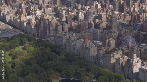 AERIAL: Flying above Upper East side overlooking green Central park in New York photo