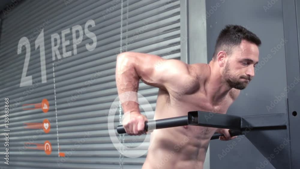 Bodybuilder performing parallel-bar dips against animated background Bodybuilder performing parallel-bar dips against animated background
