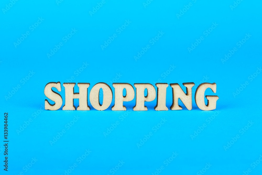 Word from the shopping of wooden letters on a blue background Word from the shopping of wooden letters on a blue background
