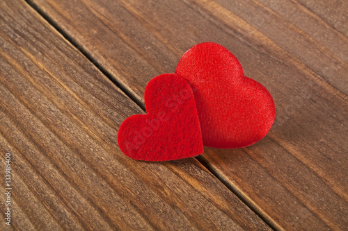 Two colored hearts on a wooden background. Valentines day.