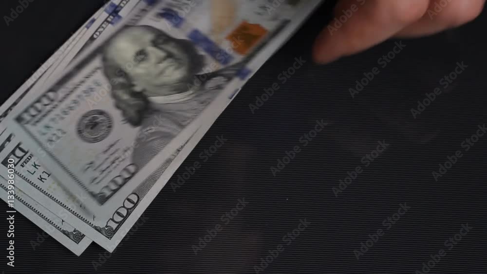 Man throws on the table 100 dollar bills. Man throws on the table 100 dollar bills.