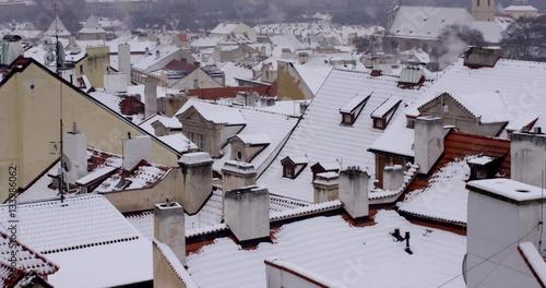 Roof tops of Prague in Winter. Snowy day
Touristic view to street of the Prague. photo