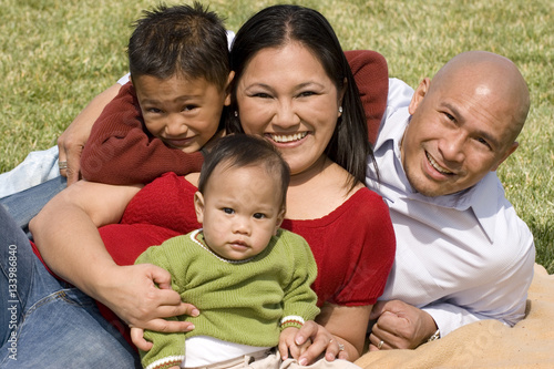 Fotografie Loving Asain parents and their smiling children.
