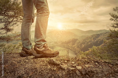 Men stay in Mountains footwear on the beautiful view.