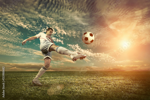 Soccer player with ball in action outdoors.