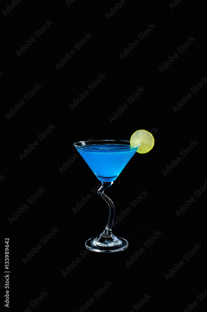 Blue alcohol cocktail with lemon slice isolated on black backgro
