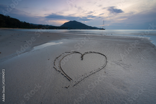 Draw heart on beach. valentine day