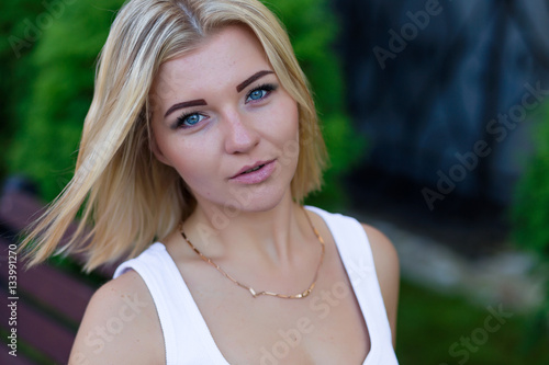 Portrait of a beautiful blonde outdoors in summer