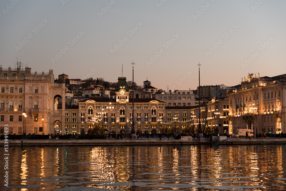 Fototapeta premium Reflections on the sea of Trieste at dusk - Historical buildings and lights