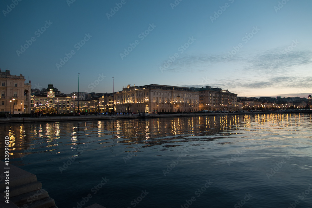 Reflections on the sea of Trieste at dusk - Historical buildings and lights