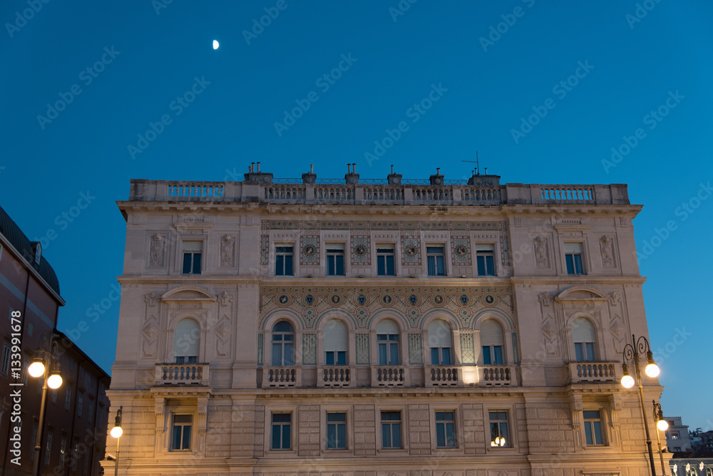 Reflections on the sea of Trieste at dusk - Historical buildings and lights