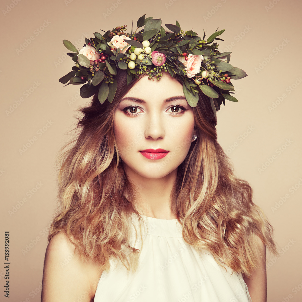 Naklejka premium Beautiful blonde woman with flower wreath on her head. Beauty girl with flowers hairstyle. Perfect makeup. Beauty fashion. Spring woman