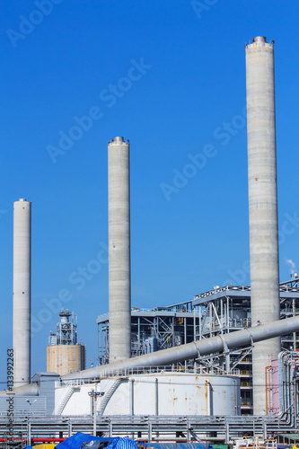 Refinery tower in petrochemical industrial plant with cloudy sky