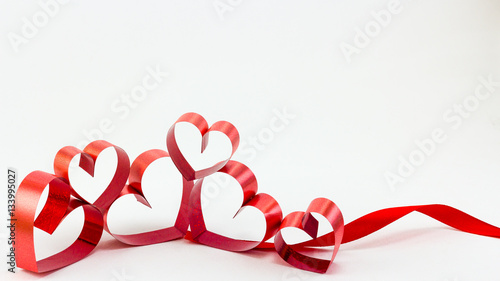 Ribbons shaped as hearts on white background, valentine day conc