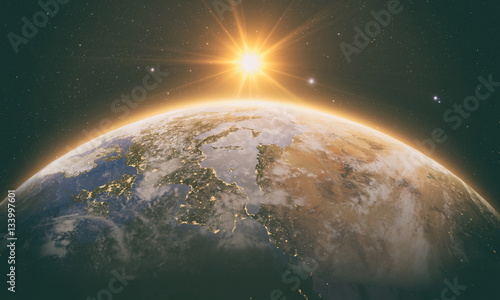 Fototapeta Naklejka Na Ścianę i Meble -  orange Sunrise over earth as seen from space. With stars background.