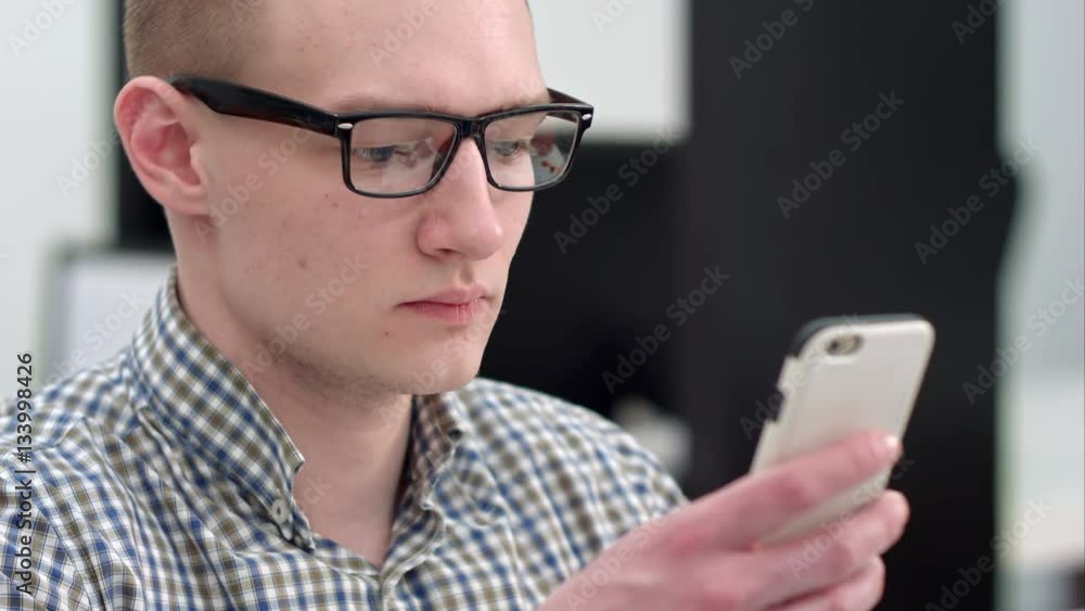 Serious office worker using mobile phone Serious office worker using mobile phone