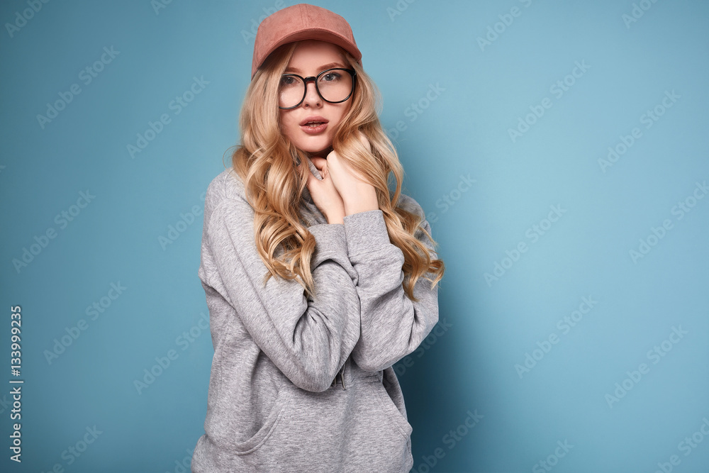 Cute positive blonde woman in a pink baseball cap Cute positive blonde woman in a pink baseball cap