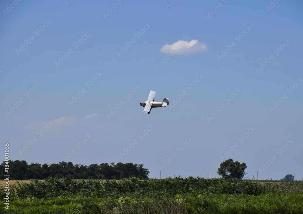 The spraying of fertilizers and pesticides on the field with the aircraft. The spraying of fertilizers and pesticides on the field with the aircraft.