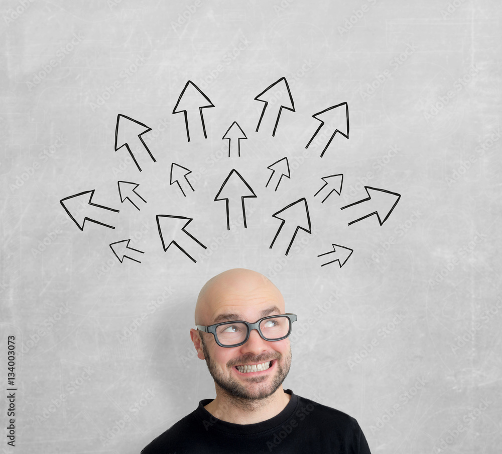 Arrows going out of the head of a young attractive smiling man g Arrows going out of the head of a young attractive smiling man g