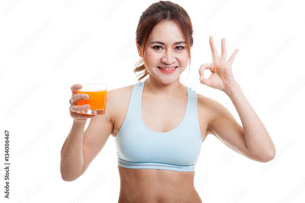 Beautiful Asian healthy girl drinking orange juice show OK sign Beautiful Asian healthy girl drinking orange juice show OK sign