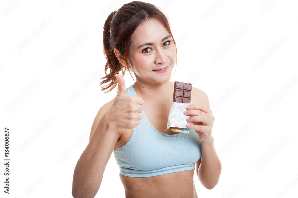 Beautiful healthy Asian girl thumbs up with chocolate. Beautiful healthy Asian girl thumbs up with chocolate.