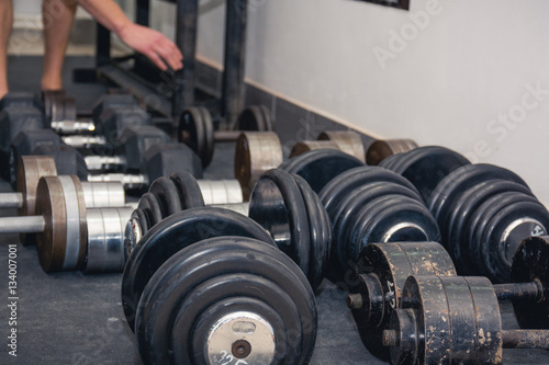 Several dumbbell lies on a floor.