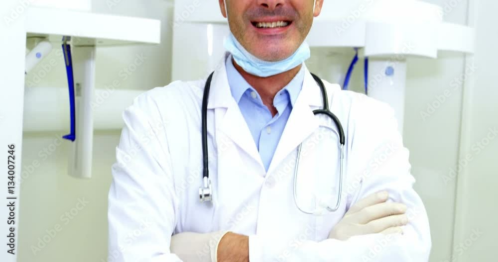 Portrait of smiling dentist standing with arms crossed Portrait of smiling dentist standing with arms crossed