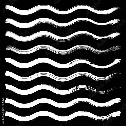 Set of black hand drawn wave lines on white background.