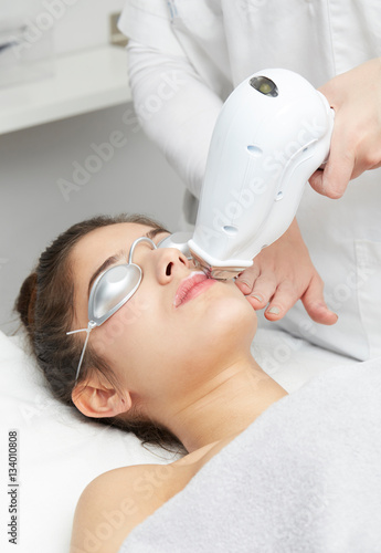 Beautician Giving Epilation Laser Treatment To Woman On lips