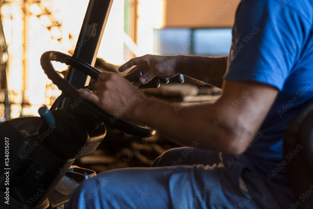 Photography worker maneuvering fork lifter