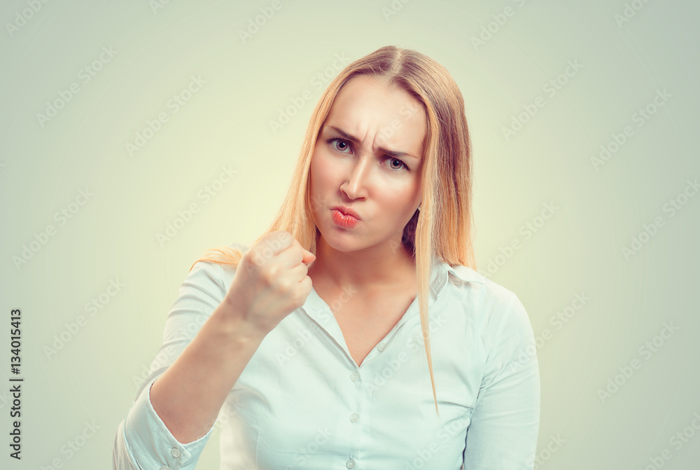 Angry woman showing fist up Angry woman showing fist up