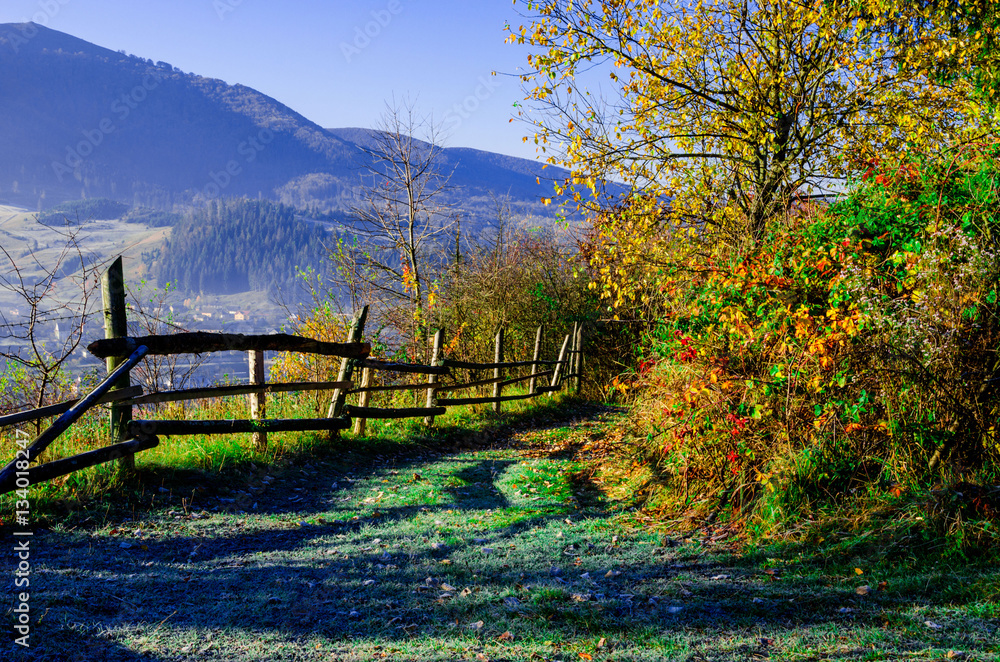 Autumn Landscape, wooden fence and blue mountains in the backgro