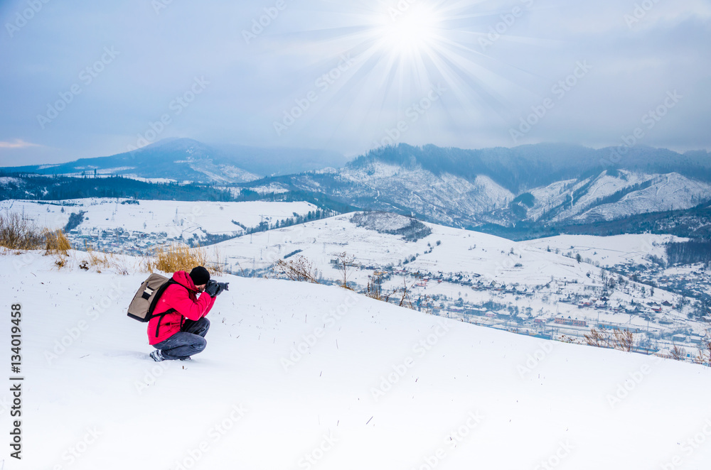 The photographer photographs the winter landscape, snow mountain