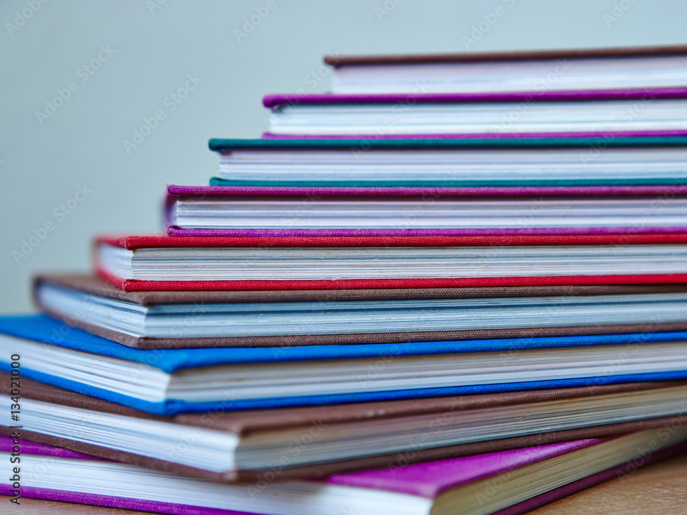 digonal pile of multicolored hardcover books
