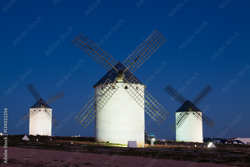 windmills at field in night